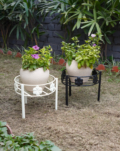 Black and ivory white planters (gamla stand) with plants