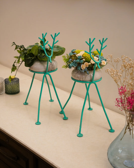 Deer plant stand holding flower pots